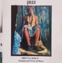 Cover of the 2022 Kom diary, a portrait of the Paramount Fon of Kom seated in blue and white cloth